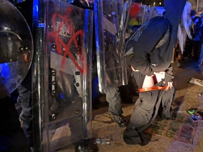 Female rioters are seen urinating and defecating at the feet of British police officers during the Kill the Bill protest in Bristol. Picture:   BPM/Australscope