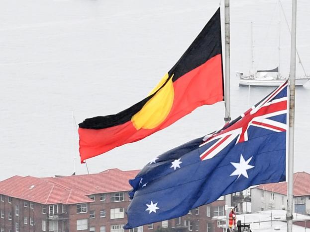 SYDNEY, AUSTRALIA - SEPTEMBER 09:  The Australian national flag and the Aboriginal flag are seen at half mast on Sydney Harbour Bridge as a sign of respect for the passing of Queen Elizabeth II on September 09, 2022 in Sydney, Australia. Queen Elizabeth II died at Balmoral Castle in Scotland aged 96 on September 8, 2022, and is survived by her four children, Charles, Prince of Wales, Anne, Princess Royal, Andrew, Duke Of York and Edward, Duke of Wessex. Elizabeth Alexandra Mary Windsor was born in Bruton Street, Mayfair, London on 21 April 1926. She married Prince Philip in 1947 and acceded the throne of the United Kingdom and Commonwealth on 6 February 1952 after the death of her Father, King George VI. Queen Elizabeth II was the United Kingdom's longest-serving monarch. (Photo by James D. Morgan/Getty Images)