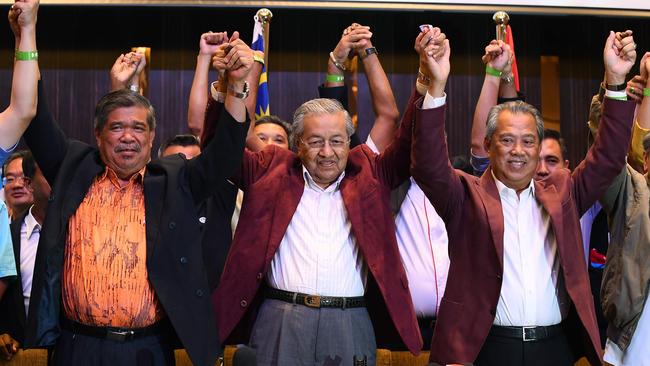 Former Malaysian prime minister and opposition candidate Mahathir Mohamad (C) celebrates with other leaders of his coalition early today. Picture: AFP.