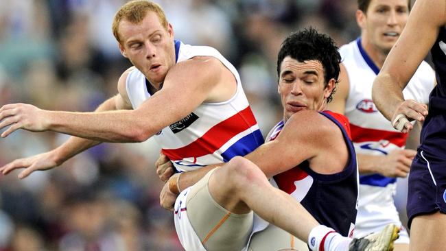 Ryan Crowley drags down Adam Cooney in 2008. Picture: Jackson Flindell