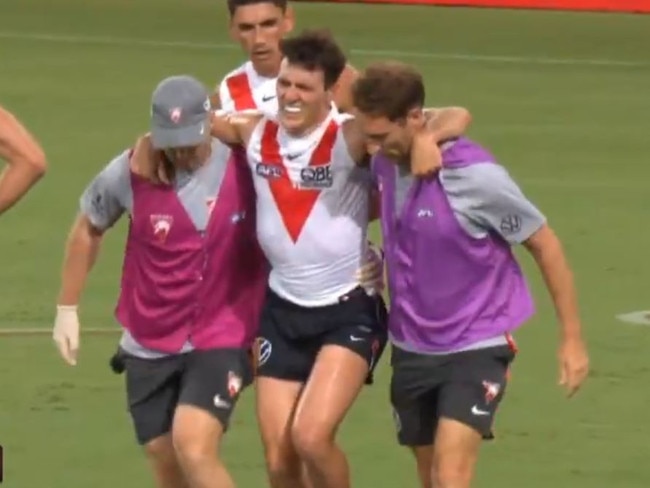 Errol Gulden is helped from the field after injuring his ankle