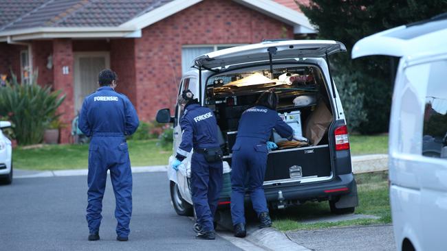 Police and forensics at the Sunshine West home the day after the deadly confrontation.