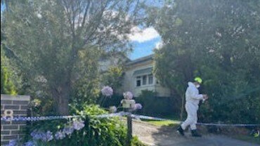 Fire technicians investigating the cause of the blaze. Photo: Erin Constable