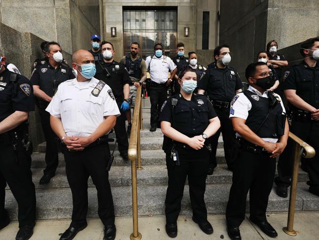 Police watch as protesters gather in New York. Picture: Getty/AFP