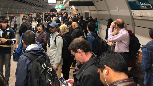 Commuters wait for the Metro service at Epping station this morning after delays caused by a fire alarm at North Ryde.