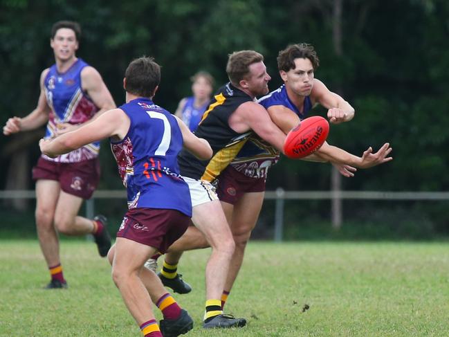 Pictured (l-r): Lions forward Thomas Lindenmayer, Tigers coach Sam Hughes tackles Branden Deslandes. Cairns City Lions v North Cairns Tigers at Holloways Beach. Dreamtime by the Sea. AFL Cairns 2024. Photo: Gyan-Reece Rocha