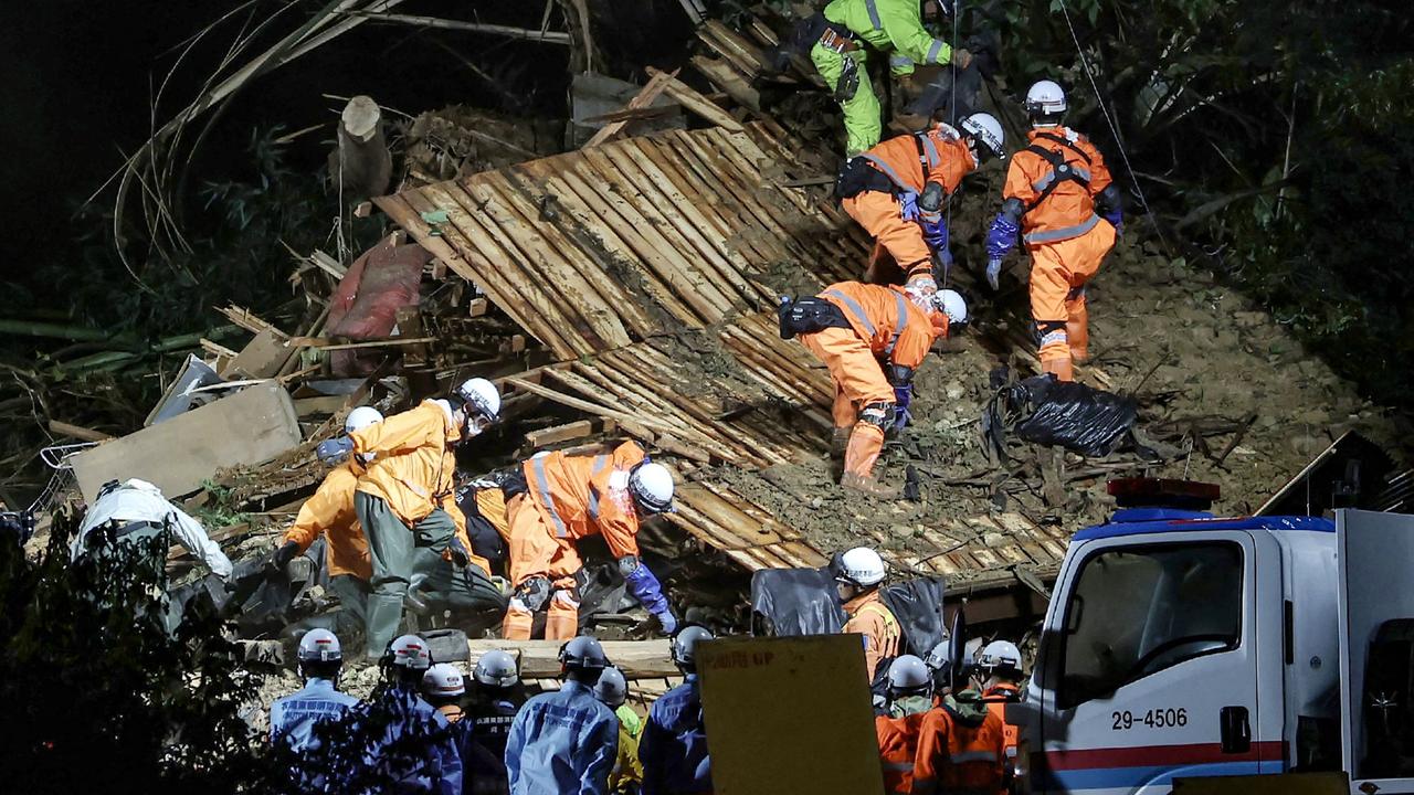 Firefighters search a house caught in a landslide in Gamagori, Aichi prefecture on August 28, 2024. Picture JIJI Press / AFP