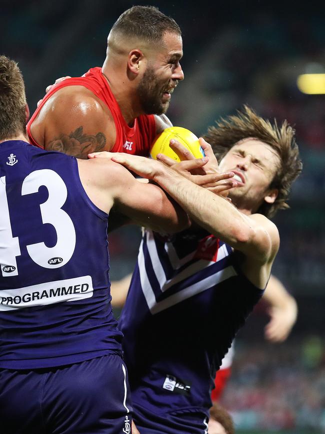 Sydney's Lance Franklin collects Fremantle's Joel Hamling. Picture. Phil Hillyard