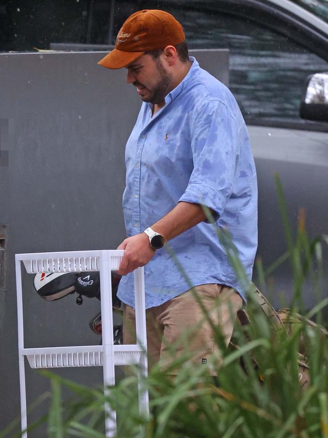 Mr Lehrmann is seen carrying his beloved golf clubs into his new home. Picture: KHAPBM/Backgrid for news.com.au