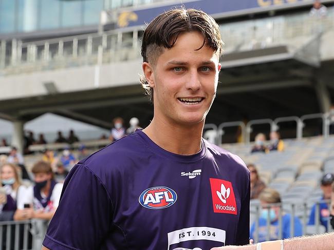 PERTH, AUSTRALIA - APRIL 03: Debutant Neil Erasmus is presented his shirt by Andrew Brayshaw of the Dockers during the 2022 AFL Round 03 match between the West Coast Eagles and the Fremantle Dockers at Optus Stadium on April 03, 2022 In Perth, Australia. (Photo by Will Russell/AFL Photos via Getty Images)