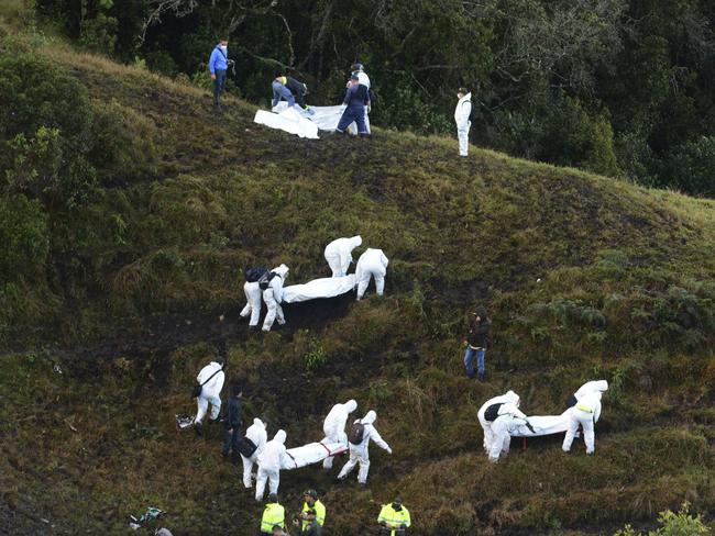 Rescue workers carry the bodies of victims of an aeroplane crash in a mountainous area near La Union, Colombia. Picture: AP