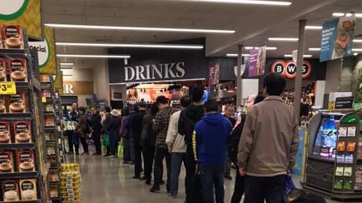 Shoppers, believed to be daigou, lining up inside Woolworths at Chadstone.