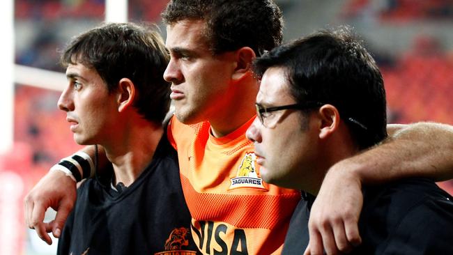 Emiliano Boffelli (C) of the Jaguares is helped off the field.