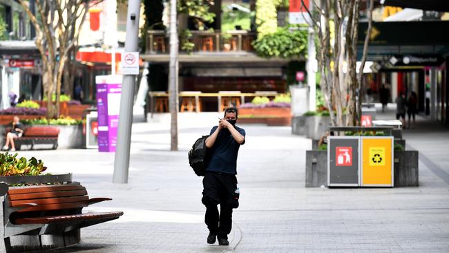 A man wears a face mask as he walks through an empty Queen Street Mall in Brisbane's CBD. Brisbane has been placed in a three-day lockdown due to a growing Covid cluster. Picture: Dan Peled/NCA NewsWire