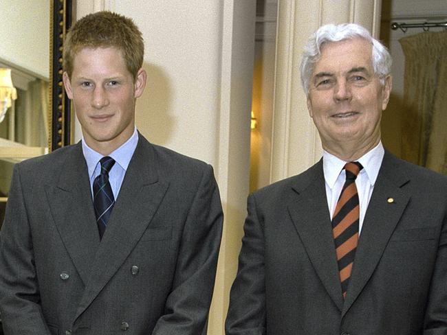 Under strict embargo until Jan 1, 2024 - as provided by the National Archives of Australia. HRH Prince Harry, flanked by Governor- General Michael Jeffery and Marlena Jeffery at Government House during his Australian ‘gap year’, Canberra, November 2003.