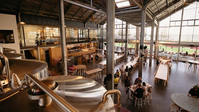 Gigantic vats are visible from the capacious dining area that sports long tables reminiscent of a European beer hall. Picture: Tourism Australia.