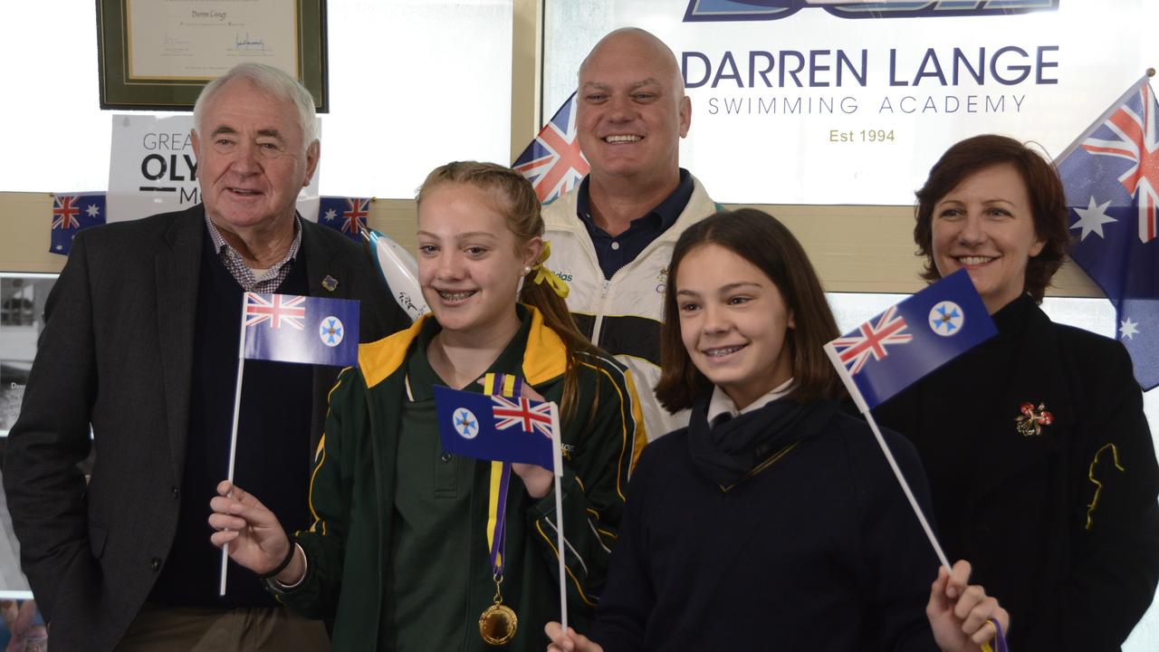 Toowoomba Regional Council Mayor Paul Antonio, former Olympian Darren Lange and Toowoomba and Surat Basin Enterprise CEO Ali Davenport with swimmers Bronte Wade, 12, and Emmi Lange, 13, celebrating the announcement of Brisbane as the host city for the 2032 Olympic Games.