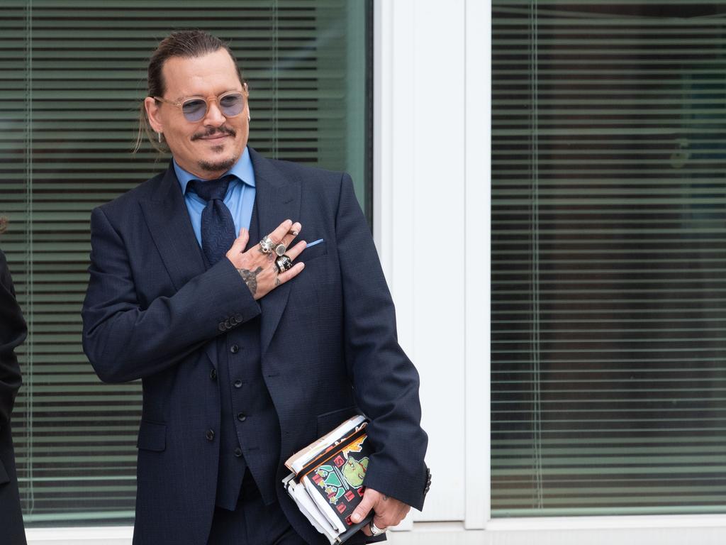 Johnny Depp gestures to fans during a recess outside court. Picture: Getty Images