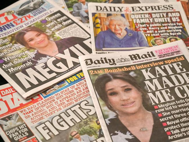 An arrangement of UK daily newspapers photographed as an illustration in Brighton on March 8, 2021, shows front page headlines reporting on the story of the interview given by Meghan, Duchess of Sussex, wife of Britain's Prince Harry, Duke of Sussex, to Oprah Winfrey, which aired on US broadcaster CBS. - Prince Harry and his wife Meghan's explosive tell-all interview with Oprah Winfrey went much further than expected and will be hugely damaging to the royal family, British media said Monday. The Duke and Duchess of Sussex, as they are formally known, delivered "enough bombshells to sink a flotilla", reported The Daily Telegraph, as the dust settled on the broadcast in the United States on Sunday night. (Photo by Glyn KIRK / AFP)