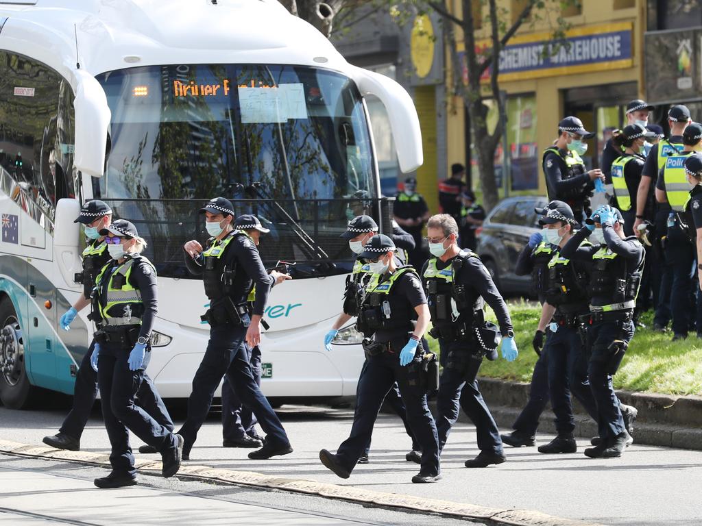 Police try to stop protesters in Melbourne. Picture: NCA NewsWire / David Crosling