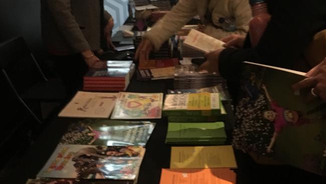 People look at books before a screening of Vaxxed: From Cover-Up to Catastrophe at Village Crown. Picture: Mark Stewart