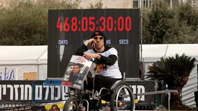 A man holds an image of a hostage taken captive by Palestinian Hamas militants in the Gaza Strip during the October 7, 2023 attacks, in Tel Aviv on January 17. Picture: AFP