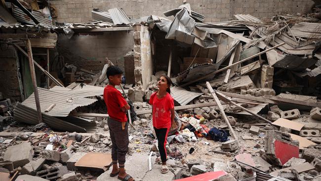 Palestinian children stand amid the debris of a house destroyed by overnight Israeli bombardment in Rafah in the southern Gaza Strip on April 27. Picture: AFP