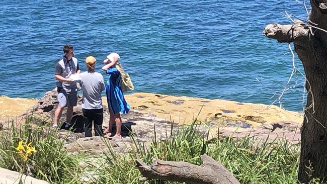 A detective from Northern Beaches Police speaks with two witnesses, who are not suspected of any wrongdoing, on Monday at the scene of the alleged assault on a North Narrabeen man at Fairlight on Sunday afternoon. Picture: Jim O'Rourke