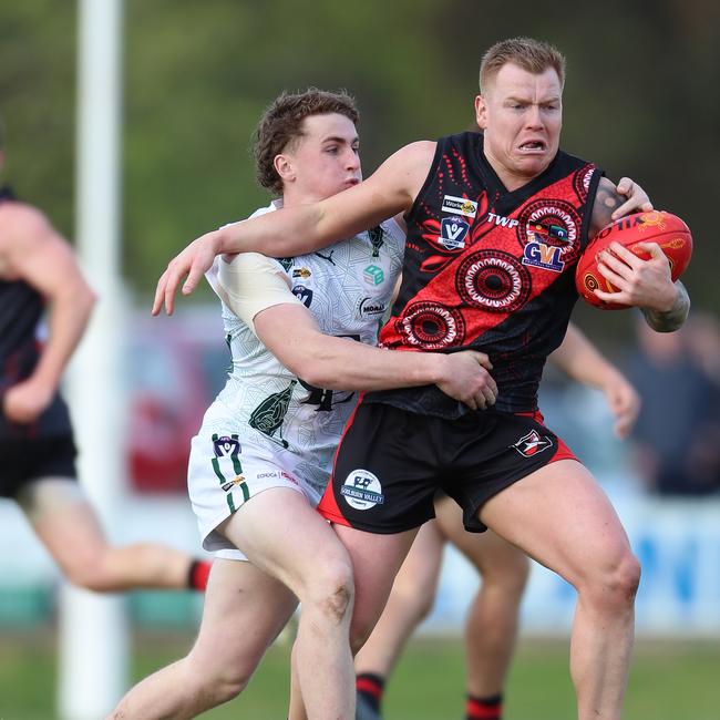 Echuca’s Callum Parsons attempts to halt Kyabram’s Hayden Gemmill breaking away with the ball.