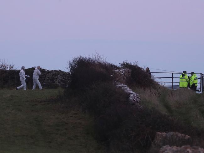 Police search a clifftop near where clothing was found. Picture: Matt Cardy/Getty Images.