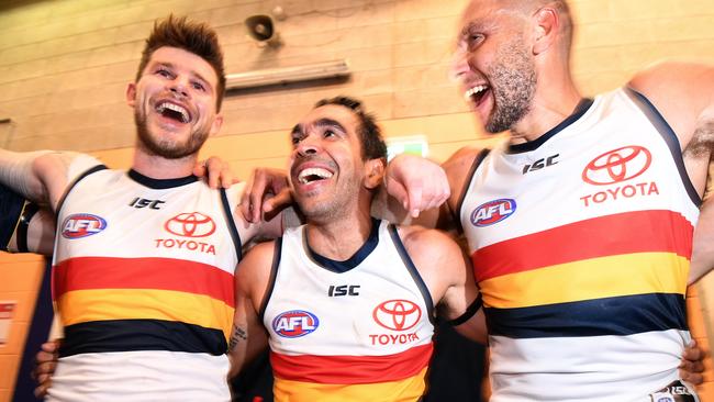 Eddie Betts (centre) and teammates Cam Ellis-Yolmen (right) and Bryce Gibbs of the Crows celebrate winning the Round 11 AFL match between the Melbourne Demons and the Adelaide Crows at TIO Stadium in Darwin, Saturday, June 1, 2019. (AAP Image/Dan Peled) NO ARCHIVING, EDITORIAL USE ONLY