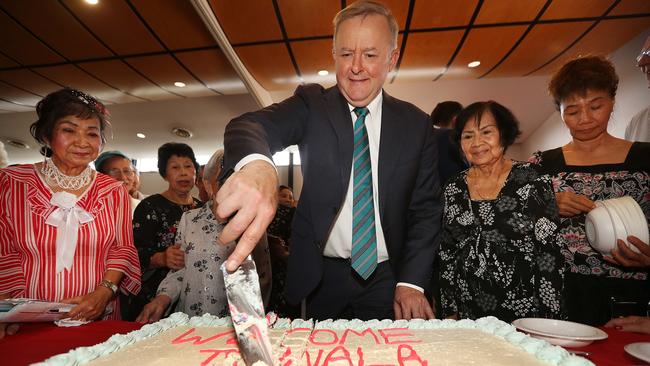 After a slice: Anthony Albanese at a Vietnamese seniors event in Inala, Brisbane. Picture: Lyndon Mechielsen