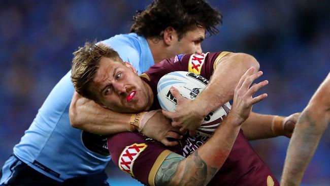 SYDNEY, AUSTRALIA — JUNE 24: Cameron Munster of the Maroons is tackled during game two of the State of Origin series between the New South Wales Blues and the Queensland Maroons at ANZ Stadium on June 24, 2018 in Sydney, Australia. (Photo by Cameron Spencer/Getty Images)