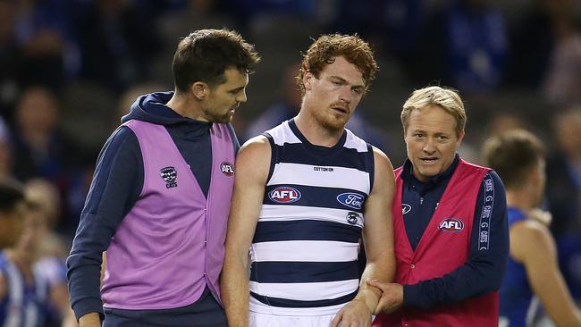 Geelong’s Gary Rohan is helped off the ground after a 3rd quarter collision . Pic: Michael Klein.