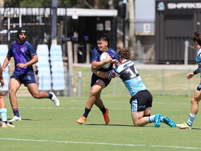 Stanley Huen is tackled by Luke Raymond\. Picture: Steve Montgomery/Ourfootyteam.com