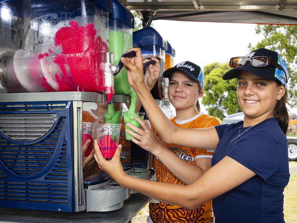 Peppa Collins (left) and Annabell Washington serve ice-cold slush puppies at the Goondir Health Services Big Buddy stall at the Warriors Reconciliation Carnival women's games at Jack Martin Centre hosted by Toowoomba Warriors, Saturday, January 18, 2025. Picture: Kevin Farmer