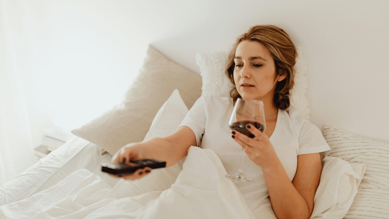 <h2>8pm: Skip the wine while you&rsquo;re watching TV</h2><p><span>Sure, it might be tempting to crash on the sofa with a glass of vino, but it&rsquo;s generally unwise. &ldquo;The body detects alcohol and sees it as a toxin, so it focuses all its resources on detoxifying that alcohol,&rdquo; explains sports scientist, Nigel Stockill. All the processes by which the body would normally start to get you ready to sleep, such as slowing down the heart rhythm, get neglected until the body has detoxified the booze.&nbsp;</span></p><p><span>&ldquo;As little as one unit of alcohol in your system at bedtime can delay the onset of restorative sleep by about an hour. Have two large glasses of wine late in the evening and sleep for six hours, and you may not get any restorative sleep &ndash; and therefore won&rsquo;t recover overnight. And you&rsquo;ll also crave carbs the next day.&rdquo;</span></p>