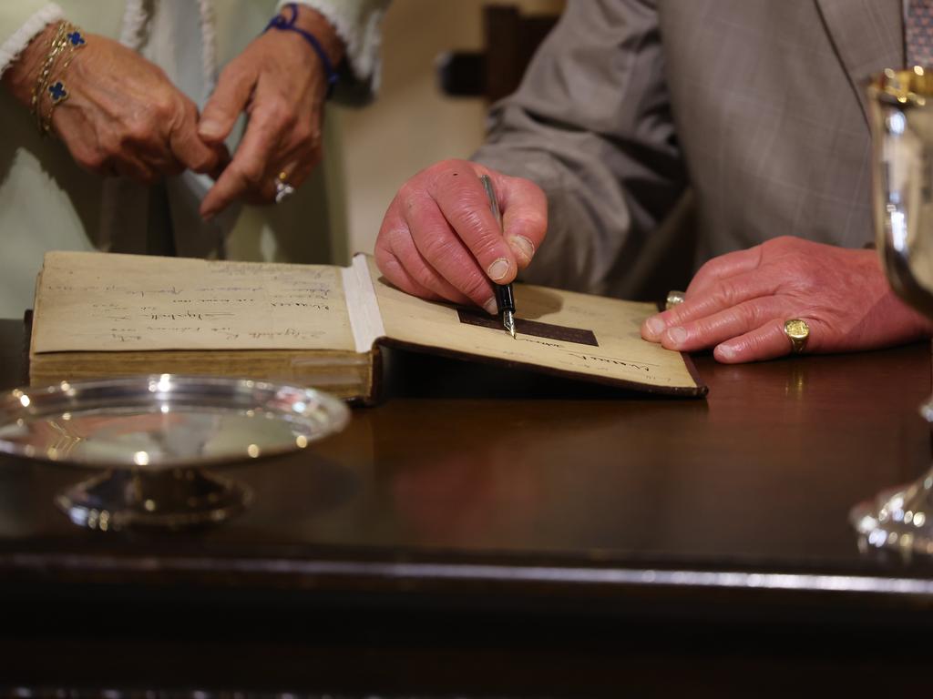 King Charles signs two historic Bibles, including one that belonged to Australia’s first minister, Richard Johnson, who was also the chaplain on the First Fleet. Picture: Rohan Kelly