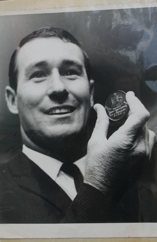 John Cunningham with the medal he received for a famous rescue at Kirra. Picture: supplied.