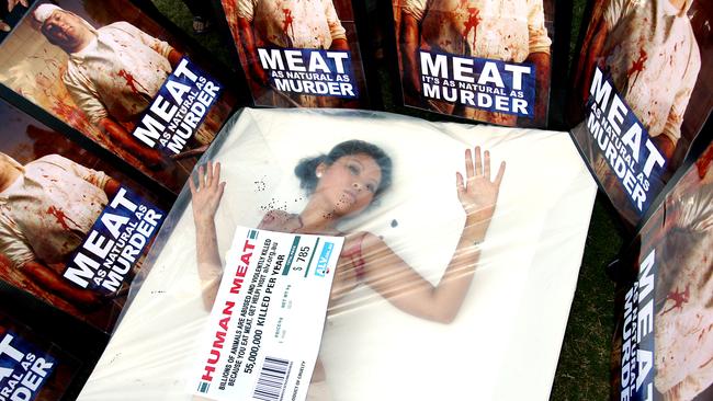 An animal liberation protester in Brisbane threw fake blood over herself and climbed into an oversized meat tray. Picture: PeterWallis