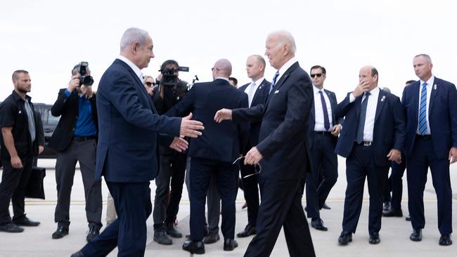 Israel Prime Minister Benjamin Netanyahu (L) greets US President Joe Biden upon his arrival at Tel Aviv's Ben Gurion airport on October 18. Picture: AFP.