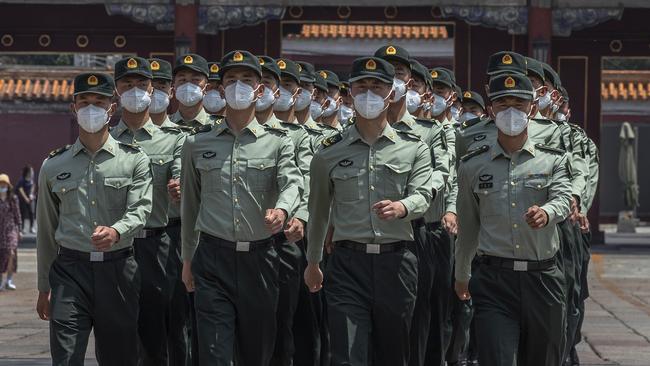 Chinese People's Liberation Army soldiers in protective face masks outside the entrance to the Forbidden City on Friday. Picture: Roman Pilipey/Pool Photo via AP