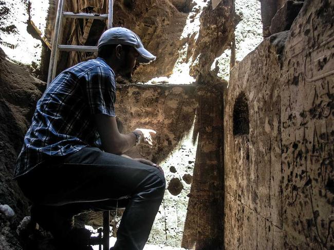 Clean-up detail ... Mud, rubble and sewage is cleaned from the memorial chapel’s walls. Picture: Luxor Times.