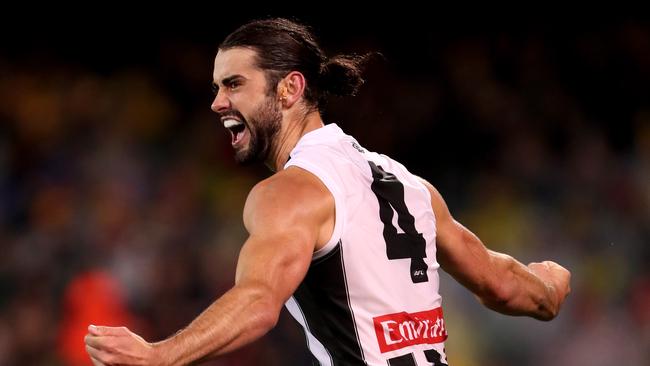 Collingwood big man Brodie Grundy is teaching younger brother Riley about body positioning in the ruck and defensive structures and plays. Picture: James Elsby (Getty).