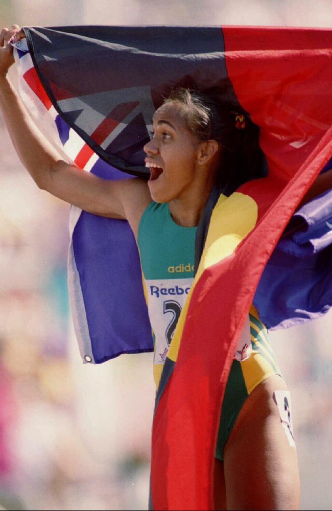 Cathy Freeman flies the Australian and Aboriginal flags in 1994. Picture: John Feder