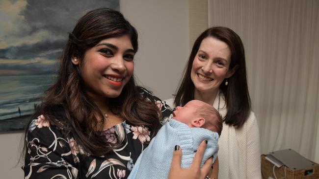 Tamsin Gascoigne with Preethi Arvind who cradles Miles whom she donated her milk to. Picture: Tracey Nearmy