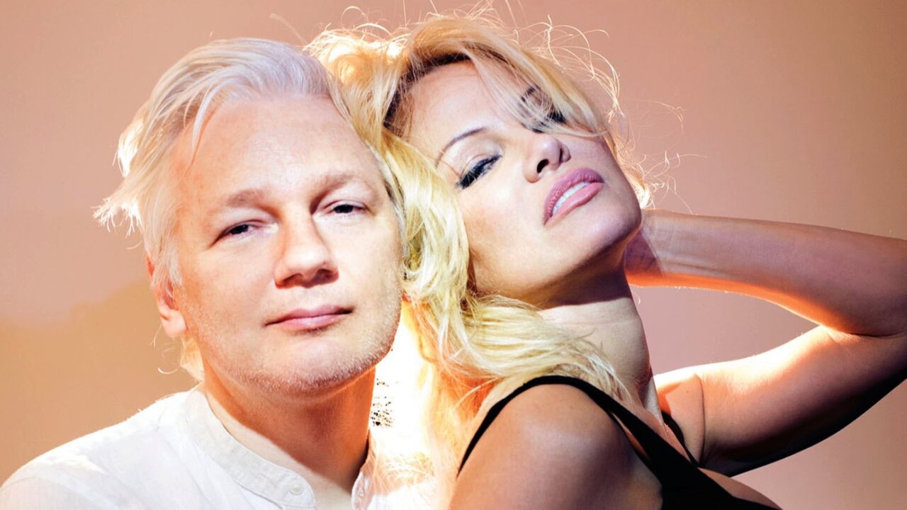 Pamela Anderson strikes a pose with Julian Assange for magazine shoot