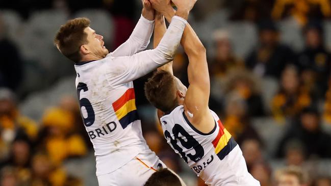 Adelaide’s Bryce Gibbs, Hawthorn’s Liam Shiels and fellow Crow Tom Doedee compete for the ball during the round 13 match at the MCG. Picture: Michael Willson/AFL Media/Getty Images.