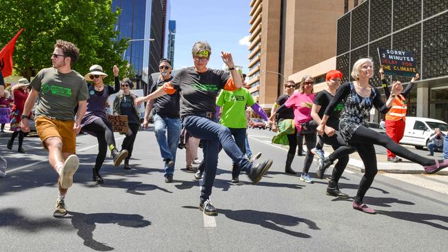 Extintion Rebellion dance to Nutbush City Limits in Flinders St, Thursday, October 10, 2019. Picture: AAP Image/Brenton Edwards