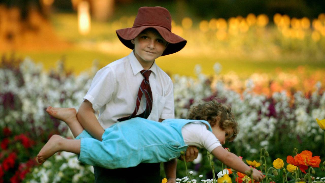 Nicholas, 9, plays with his sister Courtney, 2, at Queens Park in Toowoomba during Carnival of Flowers time. Picture: David Martinelli